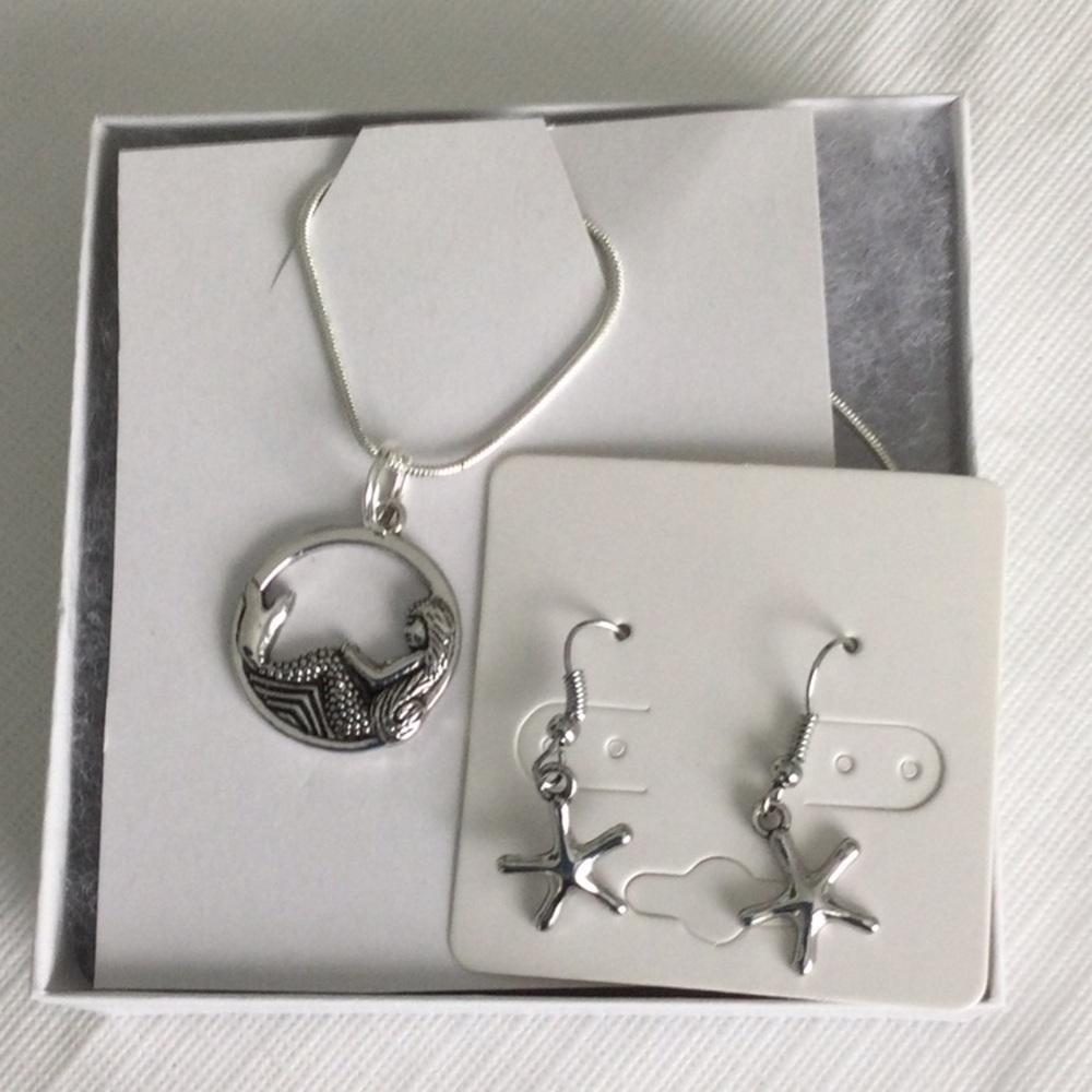 Woman’s Necklaces and Pierced Earrings color sliver.with a 19” chain NWOT